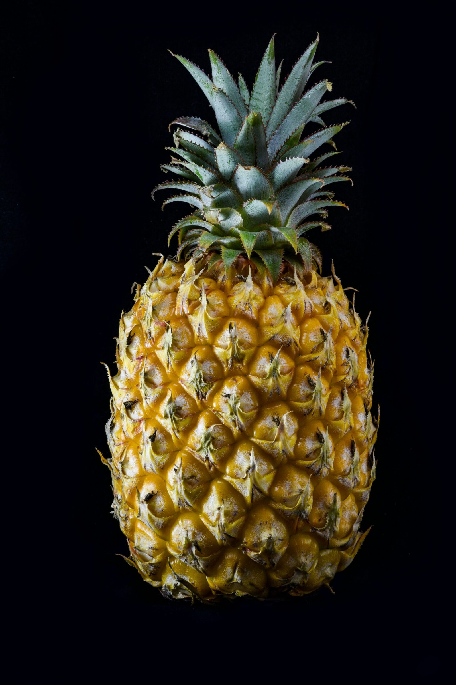 a close up of a pineapple on a black background